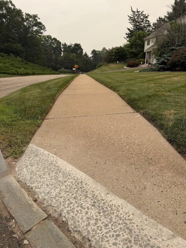 Edged sidewalk beside a manicured lawn